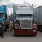Members of security forces guard trucks holding ballot boxes, in