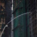 FILE PHOTO: Damaged towers at Wang Fuk Court housing complex
