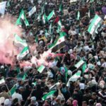 Residents of Hama demonstrate to mark the first anniversary of
