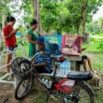 People rest at a shelter amid the clashes between Thailand