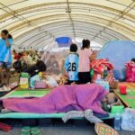 People rest at a shelter, following fresh military clashes between