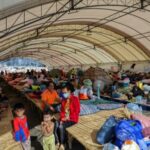 People rest at a shelter, following fresh military clashes between