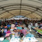People rest at a shelter, following fresh military clashes between