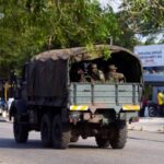 Soldiers patrol in a military vehicle after the country’s armed
