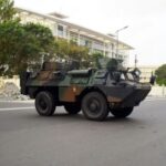 Military armoured vehicles take position, in front of the headquarters