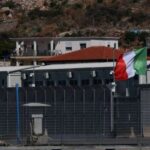FILE PHOTO: Italian and European Union flags flutter at a