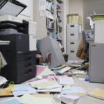 Bookshelves and documents that fell during an earthquake are seen