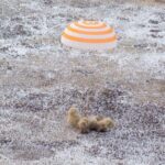 Spacecraft brings Russians, American back to earth