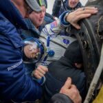 Spacecraft brings Russians, American back to earth