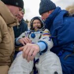 Spacecraft brings Russians, American back to earth