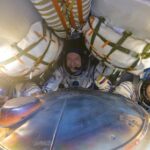 Spacecraft brings Russians, American back to earth