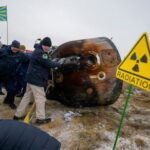 Spacecraft brings Russians, American back to earth