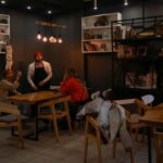 Cafe manager Melnychenko speaks with visitors in his cafe in