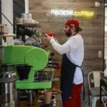 Cafe manager Melnychenko prepares coffee in his cafe in Kherson