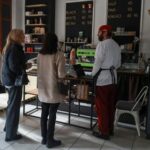 Cafe manager Melnychenko speaks with visitors in his cafe in