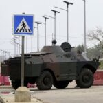 Military  armoured vehicles take position, in a street in