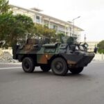 FILE PHOTO: Military armoured vehicles take position, in front of