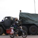 People gather at a refugee camp after evacuation, in Srei