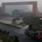 A vehicle sprays water to curb air pollution outisde Bharat