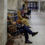 People take shelter inside a metro station during a Russian