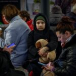 People take shelter inside a metro station during a Russian