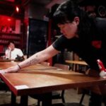 Sommelier Joyce Huang, 40, cleans a table at Wine RVLT