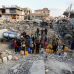 Palestinians fill up containers with water, in Jabalia refugee camp