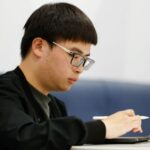 Vince, who was offered admission to Harvard University, sits at