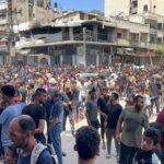 Palestinians wait to receive aid, in Gaza