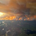 Smoke rises from a wildfire which has prompted a pre-evacuation