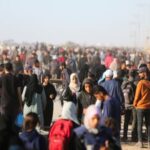 Palestinians receive aid from the U.S.-backed Gaza Humanitarian Foundation, in