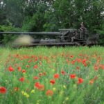 Servicemen of the Ukrainian Armed Forces ride a self-propelled gun