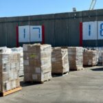 Supplies wait to be loaded on trucks to go into