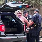 Law enforcement officers detain a suspect  after an attack