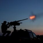 Ukrainian serviceman from mobile air defence unit fires a machine