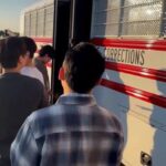 Detainees board a bus during a raid by federal agents