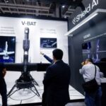 Visitors look at Shield AI’s V-BAT unmanned aerial vehicle on