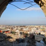 Palestinians, displaced by the Israeli military offensive, take shelter in