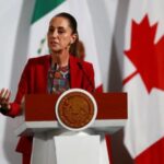 Mexican President Claudia Sheinbaum and Canadian PM Mark Carney hold