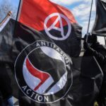 Members of the Great Lakes anti-fascist organization (Antifa) fly flags