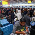 FILE PHOTO: Travellers at Heathrow Airport amid cyberattack disruptions, in