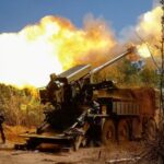 A Ukrainian serviceman fires a self-propelled howitzer towards Russian troops