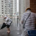 People brave strong winds as Super Typhoon Ragasa approaches, in