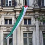 A Palestinian flag, unfurled by activists, hangs over Paris City