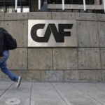A man walks past the corporate logo of the Development