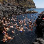 FILE PHOTO: People bath in the thermal baths at Ponta