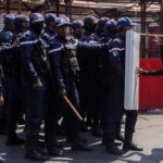 A protester pushes a riot police officer’s shield during a