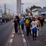 Protesters walk during a demonstration to denounce frequent power outages