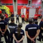 Firefighters attend a briefing at their fire station ahead of