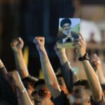 Hezbollah supporters gather at the site where the group’s late
